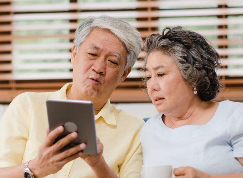 Senior Couple viewing a tablet for information on Final Expenses