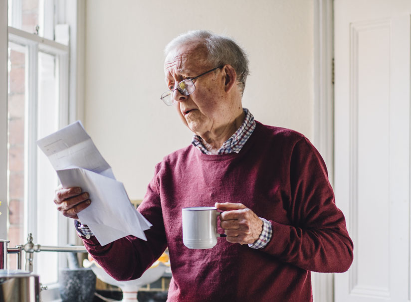 Senior Man looking at Reverse Mortgage Documents