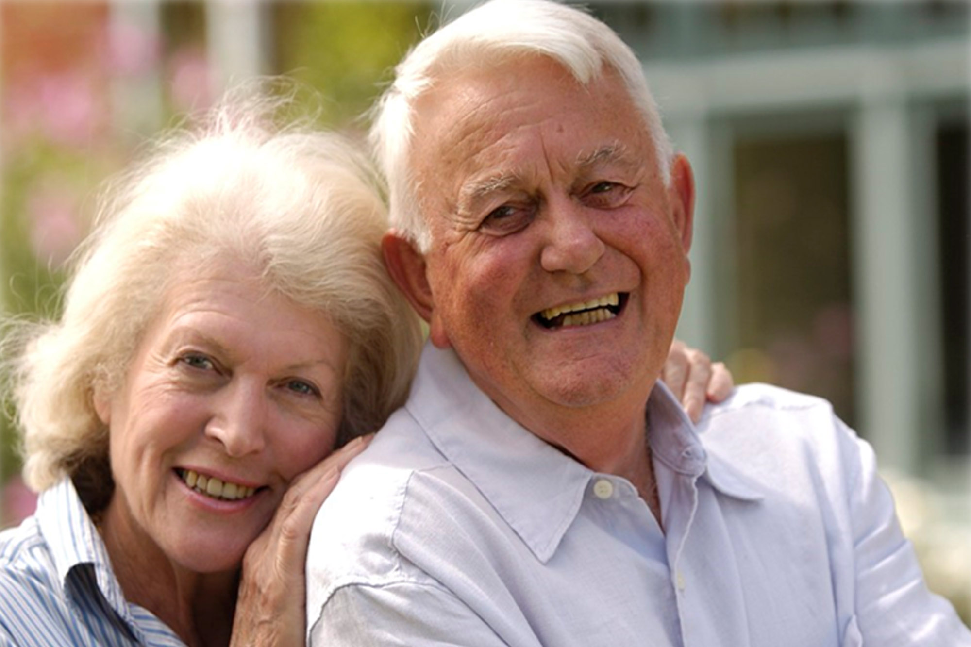 Senior couple smiling together and looking at camera