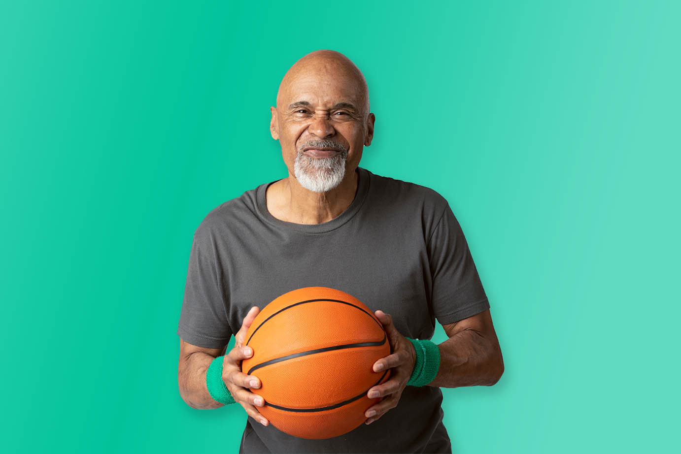 We need you! Positive african american mature man holding a basketball