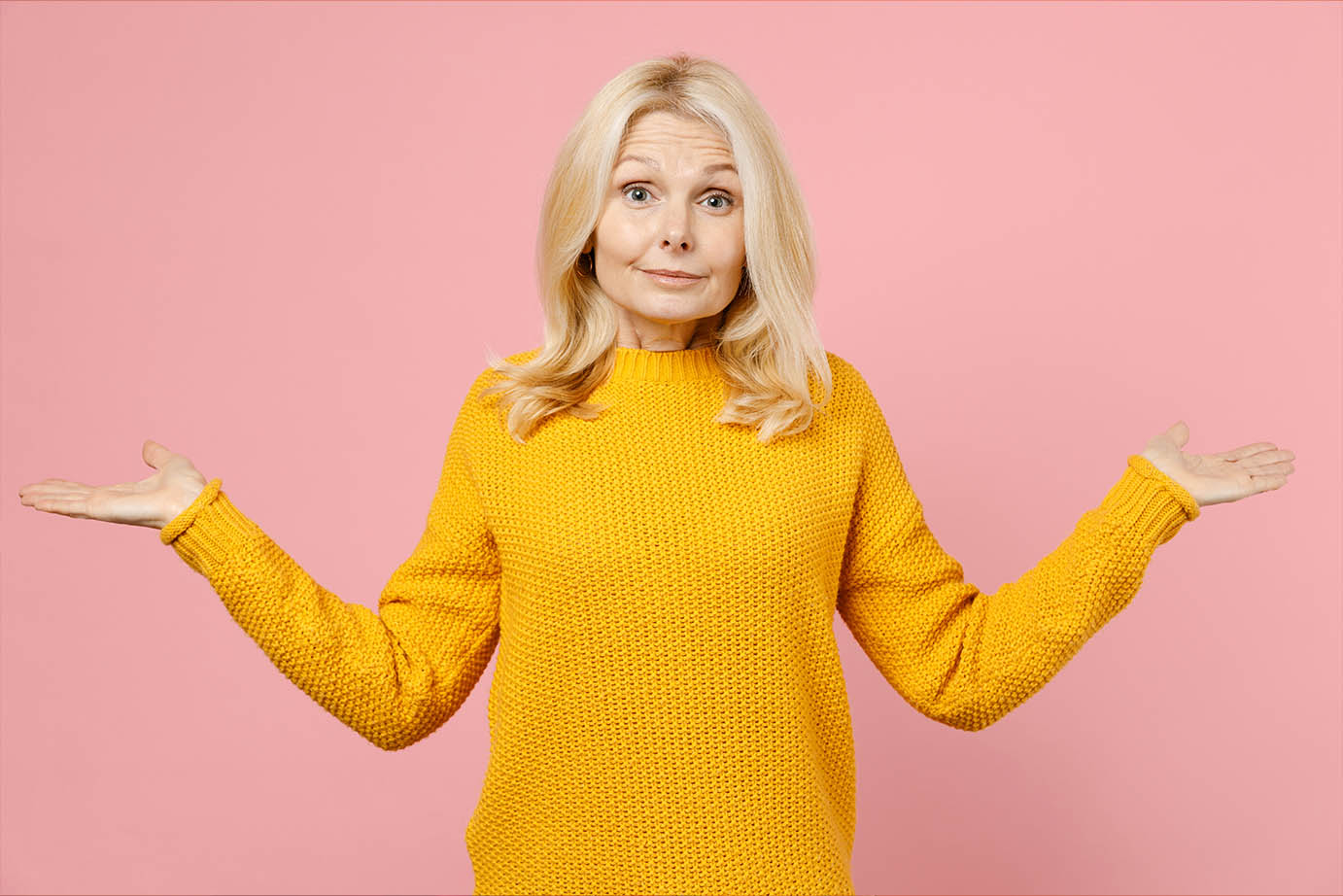 Senior woman shrugging while looking at the camera