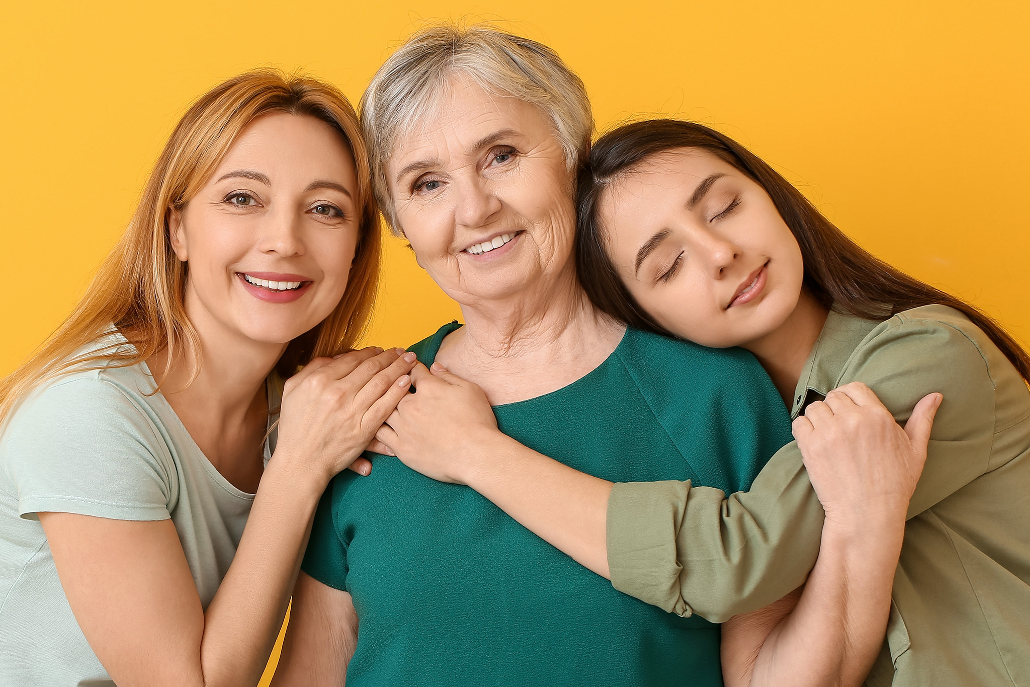 A group of smiling seniors attending a community educational seminar in a bright, welcoming room.